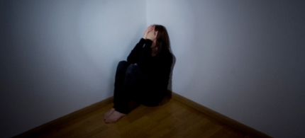7127-woman-huddled-corner-shadow-070212